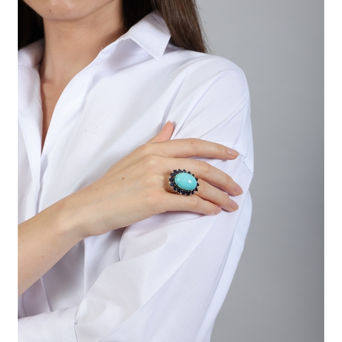 61 - A TURQUOISE, SAPPHIRE AND DIAMOND DRESS RING, FRENCH  Set with an oval-shaped turquoise cabochon at ... 