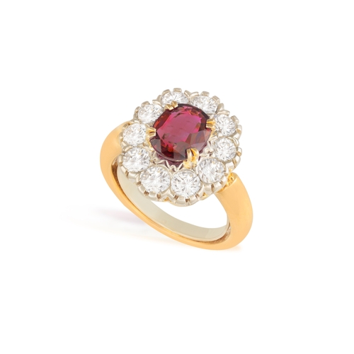 89 - A RUBY AND DIAMOND CLUSTER RING  The oval-shaped ruby, within a brilliant-cut diamond surround, moun... 