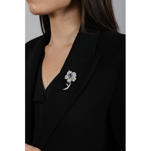 91 - A FINE SAPPHIRE AND DIAMOND BROOCH, FRENCH  Modelled as a stylised flower, centring a cushion-shaped... 