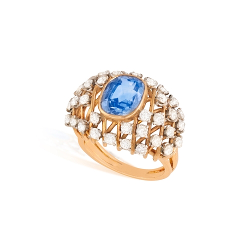 94 - A SAPPHIRE AND DIAMOND DRESS RING  The cushion-shaped sapphire weighing approximately 5.00cts, withi... 