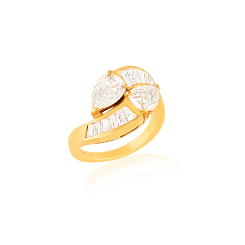 148 - A DIAMOND DRESS RING  Of crossover design, set with two pear-shaped diamonds, to tapered baguette-cu... 