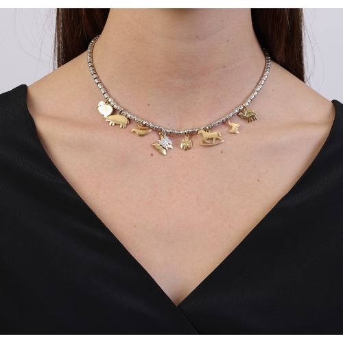 118 - DODO: A DIAMOND, SILVER AND GOLD 'GRANELLI' CHARM NECKLACE  The cable-link necklace set with texture... 