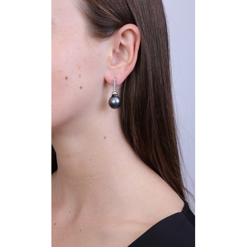 69 - A PAIR OF CULTURED PEARL AND DIAMOND PENDENT EARRINGS  Each suspending a drop-shaped baroque culture... 