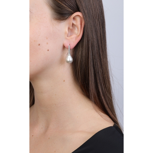 69 - A PAIR OF CULTURED PEARL AND DIAMOND PENDENT EARRINGS  Each suspending a drop-shaped baroque culture... 