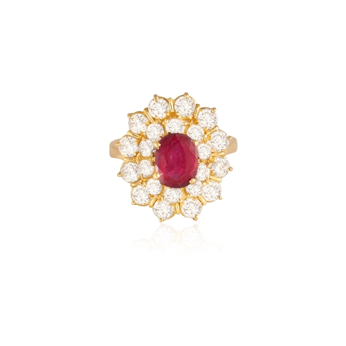 82 - A RUBY AND DIAMOND RING  Of cluster-design, centring an oval-shaped ruby, within a double-border of ... 