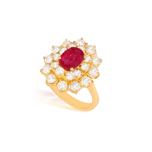 82 - A RUBY AND DIAMOND RING  Of cluster-design, centring an oval-shaped ruby, within a double-border of ... 
