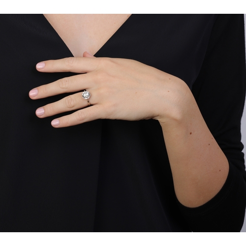 91 - A DIAMOND RING  Claw-set with an old-cut diamond weighing approximately 0.90cts, in an openwork rais... 