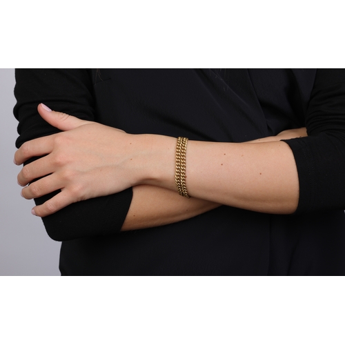 86 - AN 18K GOLD BRACELET  The double curb-link chain, with suspension loop on both terminals, clasp defi... 