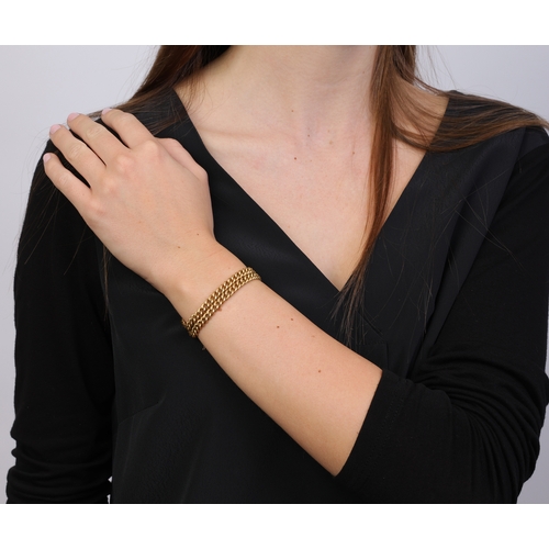 86 - AN 18K GOLD BRACELET  The double curb-link chain, with suspension loop on both terminals, clasp defi... 
