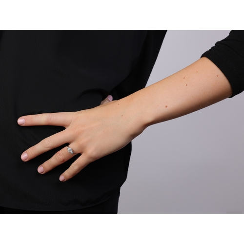 96 - A DIAMOND RING  Set with an old European-cut diamond weighing approximately 1.10cts, flanked by old ... 