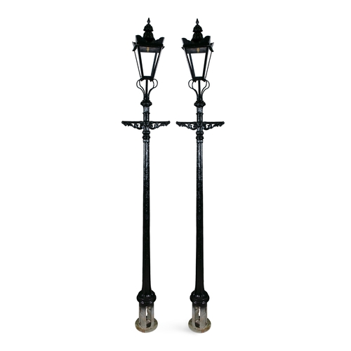 303 - A PAIR OF LARGE VICTORIAN BLACK PAINTED STREET LAMPS,  each with heavy fluted centre column, surmoun... 