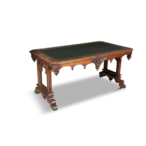 325 - A GOTHIC REVIVAL WALNUT LIBRARY TABLE 19TH CENTURY,   of shaped rectangular form, with canted corner... 