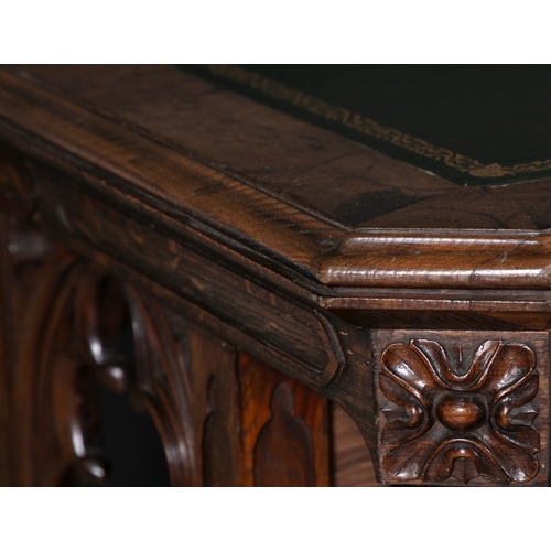 325 - A GOTHIC REVIVAL WALNUT LIBRARY TABLE 19TH CENTURY,   of shaped rectangular form, with canted corner... 