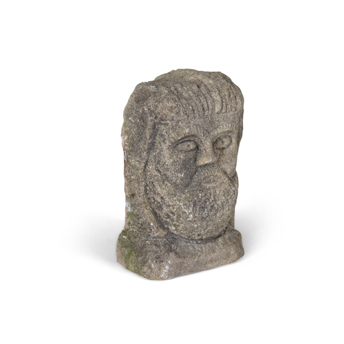 337 - THE CAVAN HEAD,  an Irish limestone carving of a male head, bearded, with arched brows and counter s... 