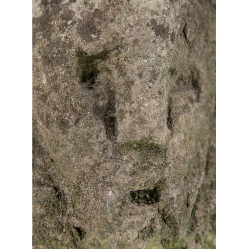 338 - THE SLANE HEAD,  A Celtic limestone fragment, carved on the angle, with sunken eyes, open mouth and ... 