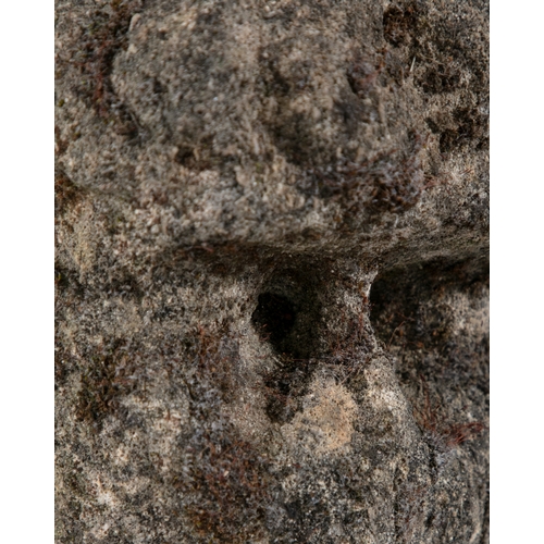 341 - A CELTIC LIMESTONE HEAD  carved in relief with furrowed brow and sunken eyes, deep open mouth, flat ... 