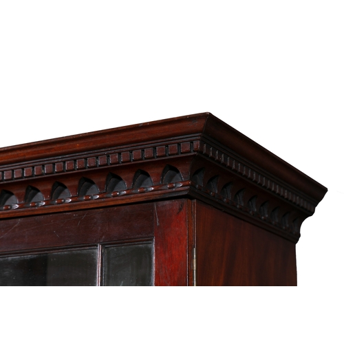 354 - A GEORGE III MAHOGANY BREAKFRONT BOOKCASE,   the moulded cornice surmounted by a pierced scrollwork ... 