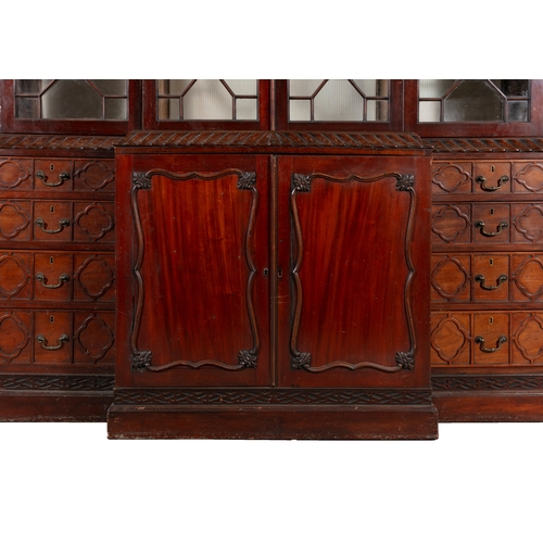 354 - A GEORGE III MAHOGANY BREAKFRONT BOOKCASE,   the moulded cornice surmounted by a pierced scrollwork ... 