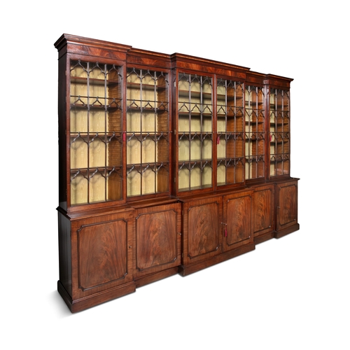 357 - A REGENCY FLAME MAHOGANY TRIPLE BREAKFRONT LIBRARY BOOKCASE IN THE MANNER OF GILLOWS CIRCA 1815,   t... 