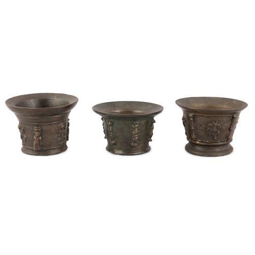 365A - THREE HEAVY CAST BRONZE MORTARS, 17TH CENTURY, each of flared circular form, the exteriors cast with... 