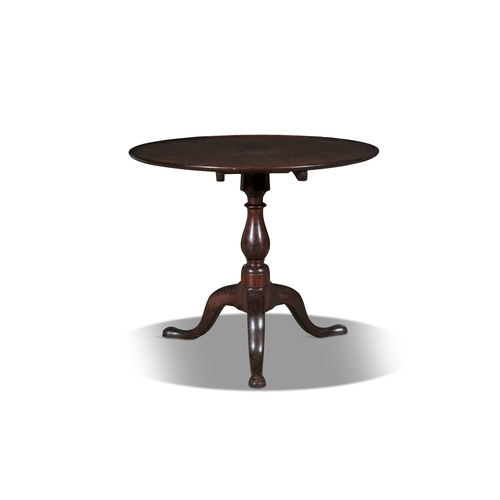 388 - A GEORGE III MAHOGANY TILT-TOP WINE TABLE,   the dished circular top on a turned central baluster co... 