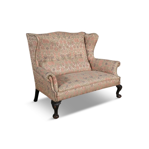 394 - A DOUBLE WING BACK SETTEE 19TH CENTURY,    upholstered in floral damask against a gold ground, with ... 