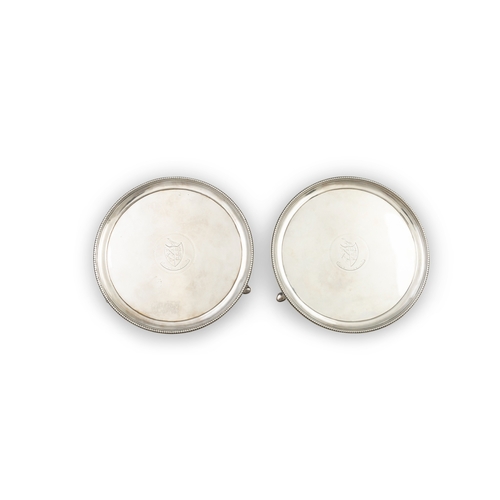 400 - A PAIR OF GEORGE III IRISH SILVER CIRCULAR SALVERS,  Dublin c.1785, mark of John Lloyd, with raised ... 