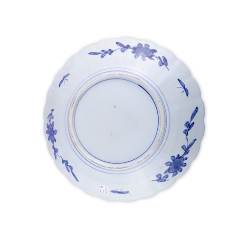 433 - A JAPANESE PORCELAIN CIRCULAR CHARGER IN BLUE ON WHITE 19TH CENTURY,  of circular form with scallop ... 