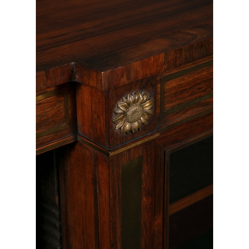 445A - A REGENCY BRASS INLAID ROSEWOOD BREAKFRONT BOOKCASE,  the shaped rectangular top above a frieze with... 