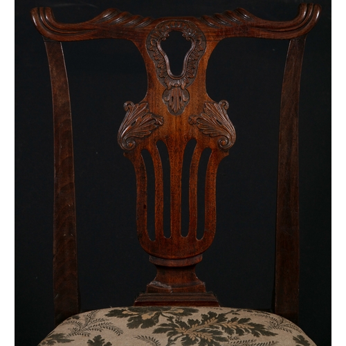 463 - A SET OF FOUR GEORGE III CARVED MAHOGANY SIDE CHAIRS,   each with shaped top rail above an openwork ... 