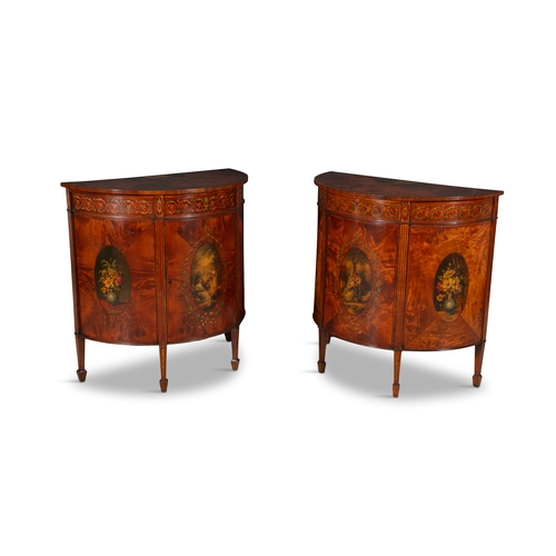 473 - A PAIR OF GEORGE III STYLE PAINTED SATINWOOD DEMI-LUNE CUPBOARDS,  the figured mahogany top painted ... 