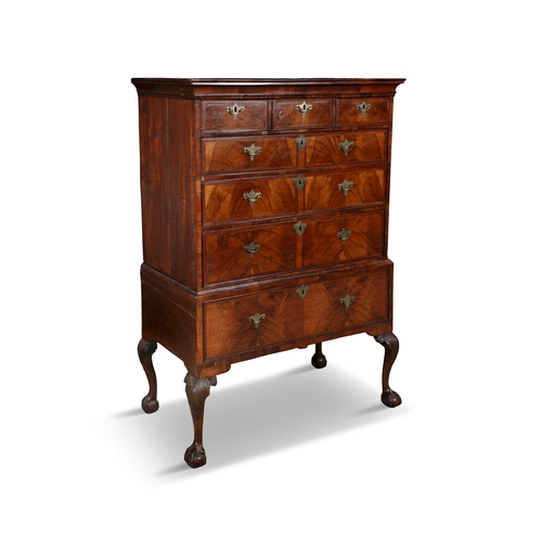 517 - A GEORGE II OAK AND WALNUT CHEST ON STAND EARLY 18TH CENTURY  fitted with cavetto cornice above a ro... 