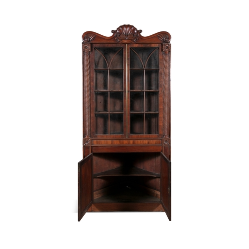 526 - AN IRISH WILLIAM IV MAHOGANY CORNER CABINET, PROBABLY CORK,  the scrollwork cornice carved with cent... 