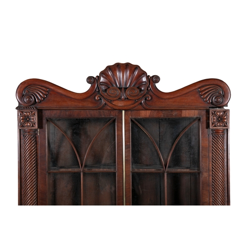 526 - AN IRISH WILLIAM IV MAHOGANY CORNER CABINET, PROBABLY CORK,  the scrollwork cornice carved with cent... 