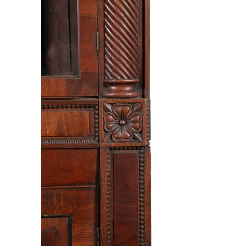 526 - AN IRISH WILLIAM IV MAHOGANY CORNER CABINET, PROBABLY CORK,  the scrollwork cornice carved with cent... 