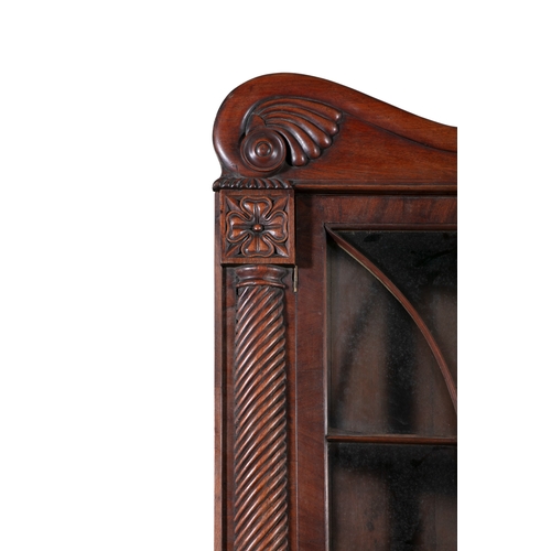 526 - AN IRISH WILLIAM IV MAHOGANY CORNER CABINET, PROBABLY CORK,  the scrollwork cornice carved with cent... 