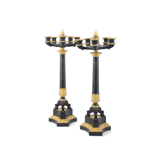 533 - A PAIR OF 19TH CENTURY EMPIRE STYLE PARCEL GILT BRONZE FOUR-LIGHT CANDELABRAS,  Each 63cm high