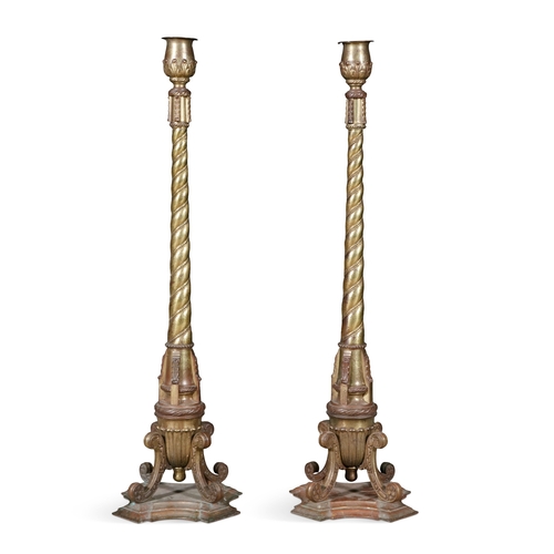 536 - A PAIR OF TALL ECCLESIASTICAL GILT METAL COLUMN CANDLESTANDS,  each with tulip shaped holders, above... 