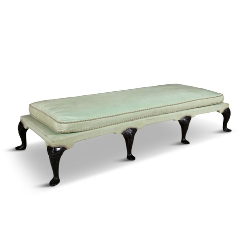 548 - A CARVED MAHOGANY EIGHT-LEG OTTOMAN 19TH CENTURY,  upholstered in green Moira silk fabric, with loos... 