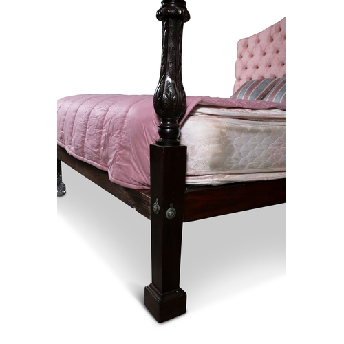 559 - A GEORGE III STYLE MAHOGANY FOUR-POSTER BED,  with mahogany stop-fluted and foliate carved posts on ... 