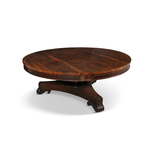 561 - A GEORGE IV ROSEWOOD CIRCULAR BREAKFAST TABLE   on plain centre column and concave platform base and... 