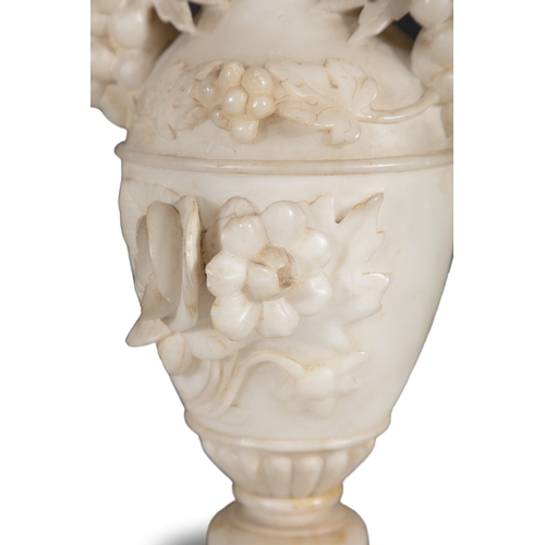 571 - A PAIR OF ALABASTER URNS,  of amphora form, each with outturned carved leaf rims, with naturalistic ... 