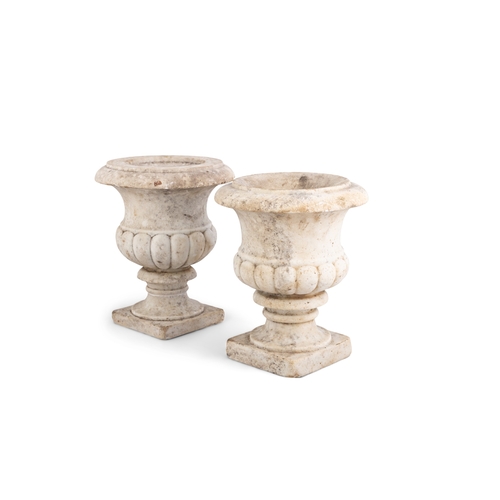 572 - A NEAR PAIR OF 19TH CENTURY CLASSICAL MARBLE URNS,  of campagna form, with out turned rims, demi-flu... 