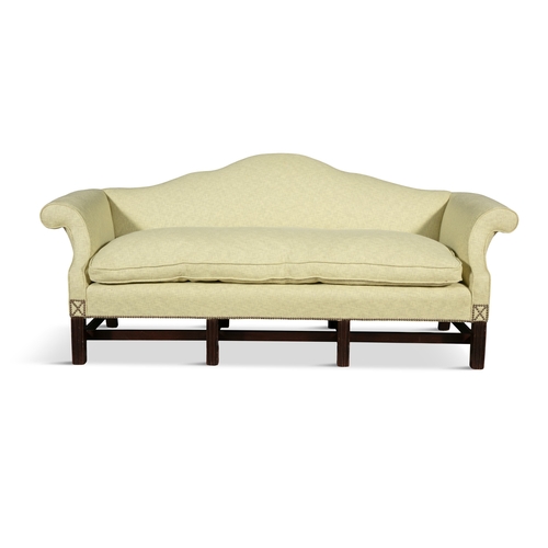 579 - A MAHOGANY FRAMED HUMP BACK THREE SEAT SOFA 19TH CENTURY,  upholstered in light green fabric, with o... 