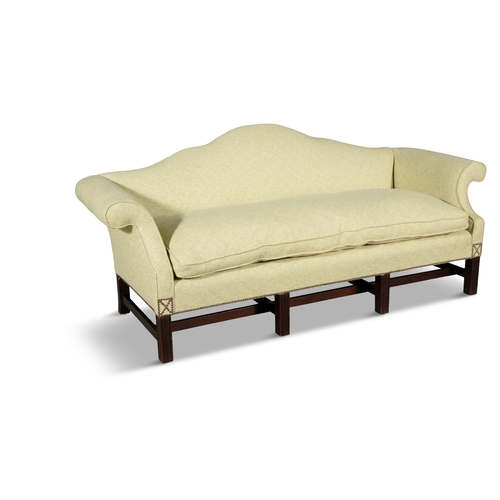 579 - A MAHOGANY FRAMED HUMP BACK THREE SEAT SOFA 19TH CENTURY,  upholstered in light green fabric, with o... 