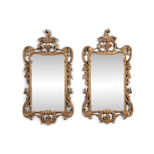 580 - A PAIR OF IRISH GEORGE III GILTWOOD WALL MIRRORS OF ROCOCO STYLE,   each with rectangular plate flan... 