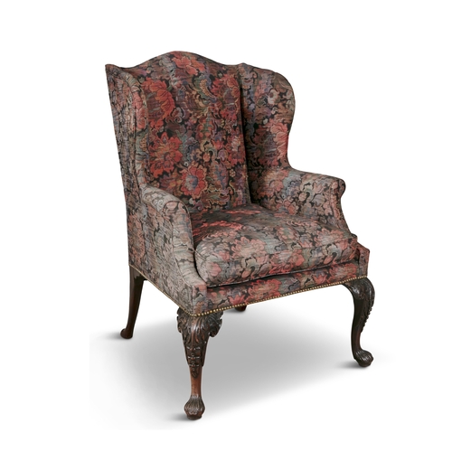 583 - AN IRISH GEORGE III MAHOGANY FRAMED WINGBACK ARMCHAIR,  the padded back and seat covered in a dark f... 