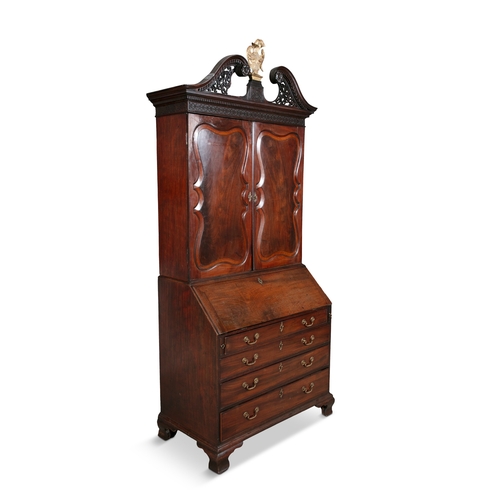 589 - AN IRISH GEORGE II MAHOGANY BUREAU BOOKCASE CIRCA 1740,   the broken swan neck pediment with pierced... 