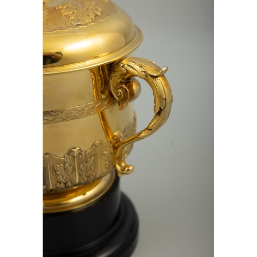 611 - THE WATERLOO PURSE 1926,  A silver-gilt trophy cup in the form of an 17th century porringer and cove... 