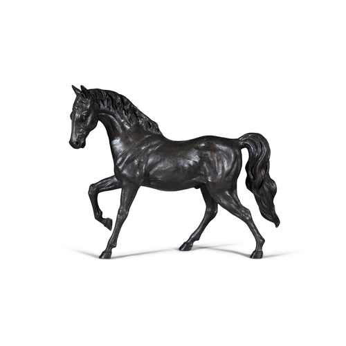 619 - A LARGE STRIDING BRONZE HORSE  68cm high, 90cm long